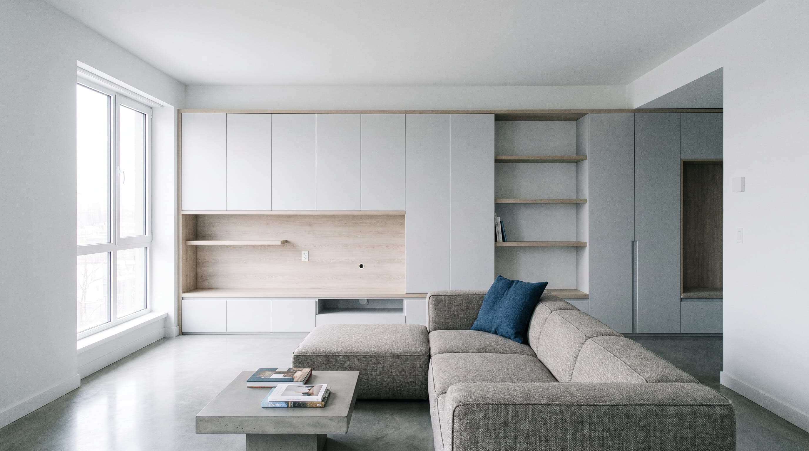Fitted wardrobes and upholstered seating in a daylit living room